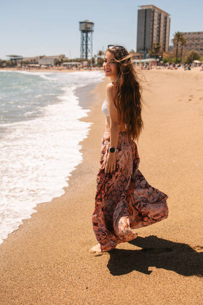 istock Woman walking by the sea 2149691536