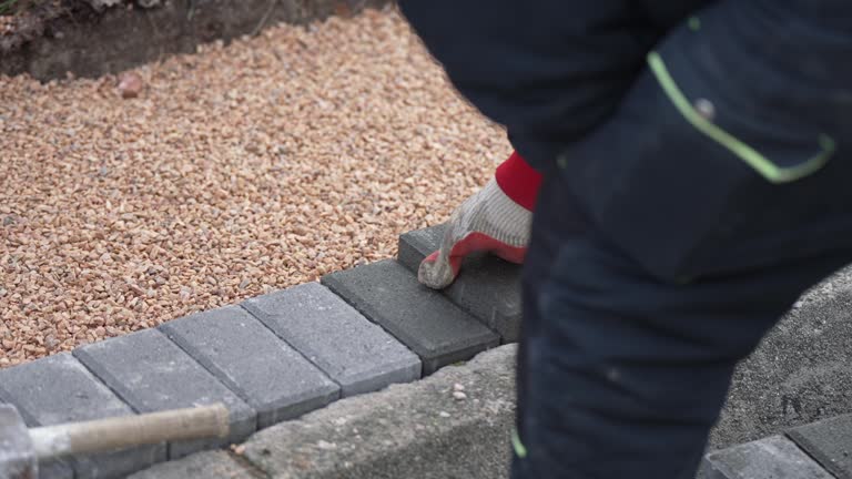 Installing new sidewalk made of concrete interlocking paving blocks, slow motion