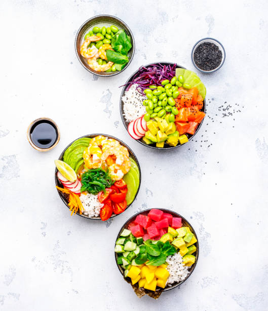 istock Poke bowls with vegetables and seafood in assortment, white table background, top view 2149693725