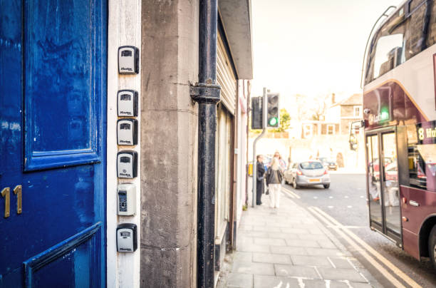 Lockboxes for Airbnb rentals in Edinburgh Edinburgh, Scotland - Lock boxes outside a tenement main door holding keys to flats in Canonmills, Edinburgh, used for short term rentals. key package stock pictures, royalty-free photos & images