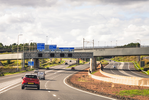 Glasgow, Scotland - Light daytime traffic on the M8 motorway, with a Welcome to Glasgow sign at the junction for the M73.
