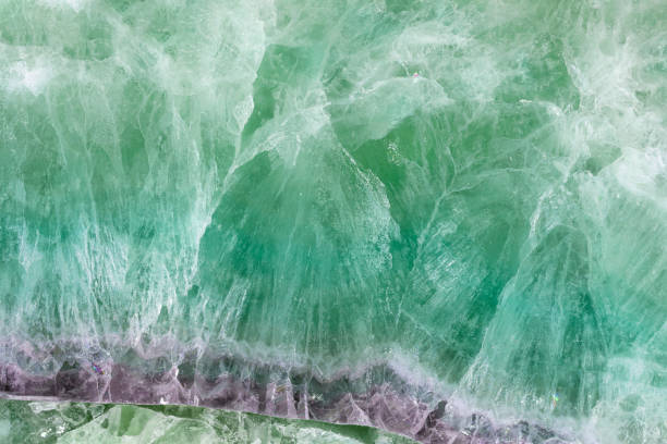 Green Fluorite. Gemstone background. Matt natural semi precious mineral pattern.
