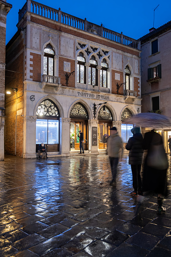 Venice, Italy - March 18, 2024 - Teatro Italia at night in Cannaregio district with Despar supermarket inside, Neo-Gothic and Art Nouveau style building, opened as a movie theater in 1916.