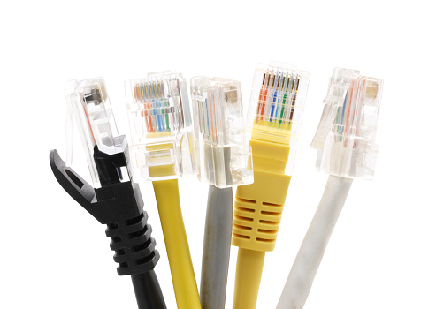 Multi colored network cables with molded RJ45 plug isolated on white background