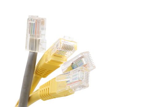 Gray and yellow network cables with molded RJ45 plug isolated on white background