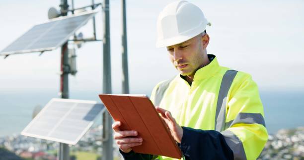 istock Man, tablet and engineer for solar panel inspection, research or alternative energy maintenance on rooftop. Male person, contractor or technician on technology for photovoltaic checklist in city 2149701400