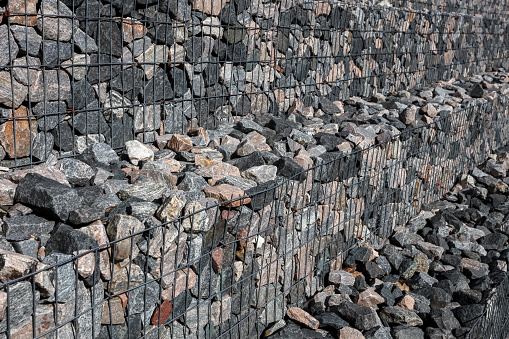A stepped wall of gabions. Shot from an angle. Selective focus