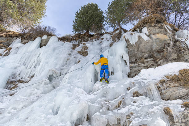 Beautiful winter view of frozen icicles on snowy extreme terrain in Norway.