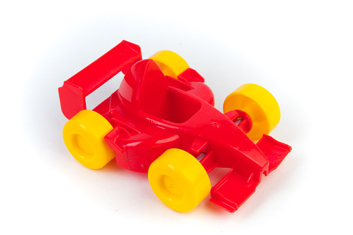 toy motor racing car, for children's fun and play, front closeup view, isolated on white background