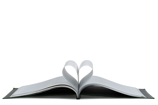 Open hardback book, page decorate into a heart shape on a white background, for love in Valentine's. love with open book heart