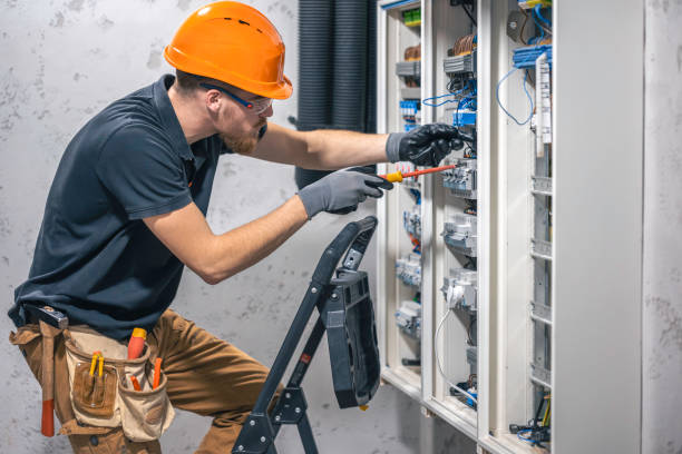 istock A male electrician works in a switchboard with an electrical connecting cable. 2149705026