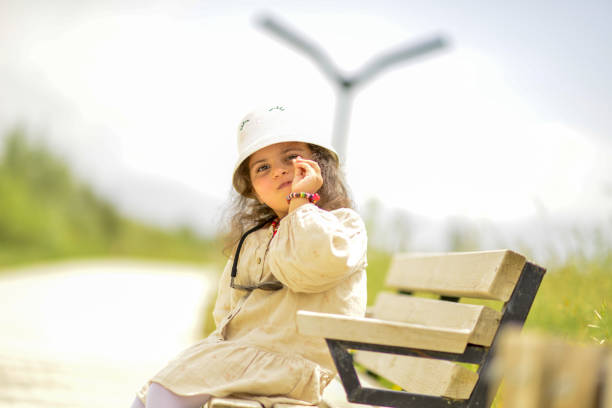 little girl playing in the park on a sunny spring day