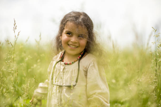 little girl playing in the park on a sunny spring day