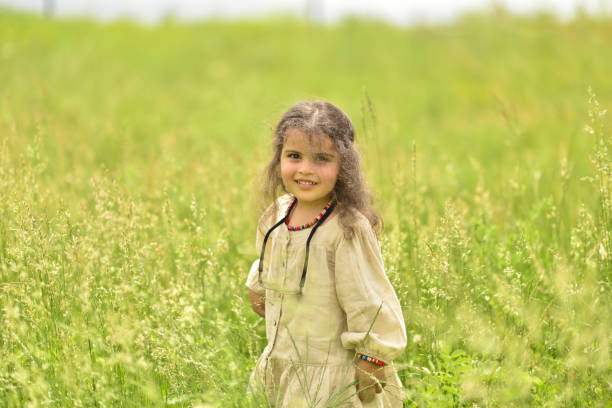 little girl playing in the park on a sunny spring day