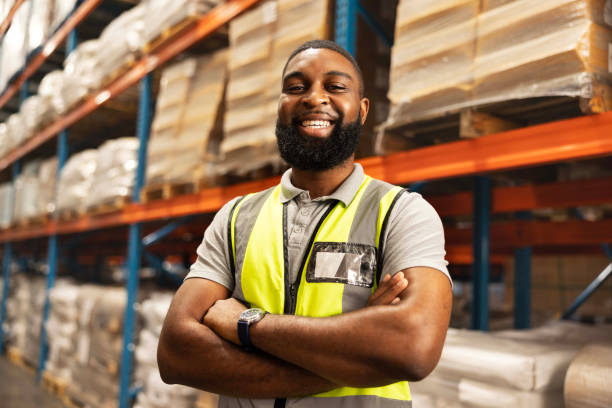istock Black man, portrait and smile with confidence in warehouse for logistics, supply chain or storage management. African male person or happy employee with arms crossed in shipping industry at depot 2149706236