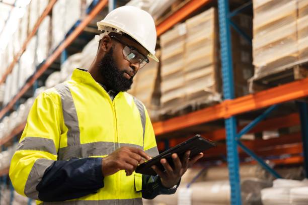 istock Tablet, logistics and man with stock in warehouse reading email for ecommerce delivery information. Shipping, research and African male industry worker on digital technology for package in factory. 2149706256