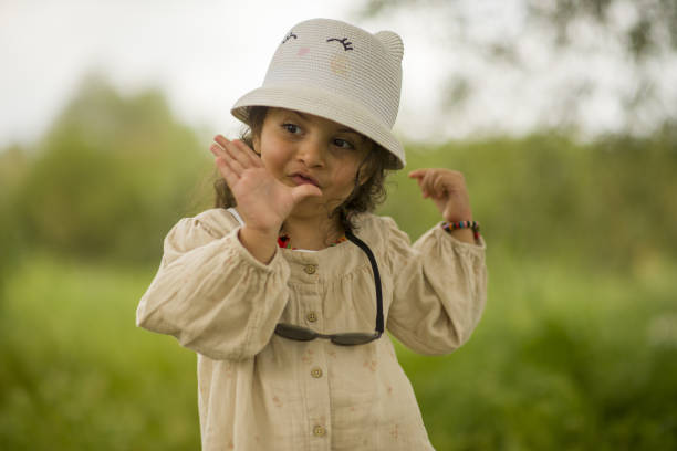 little girl playing in the park on a sunny spring day