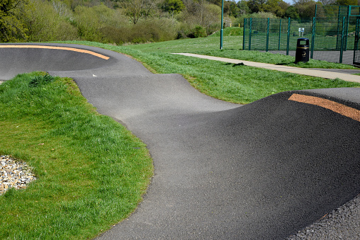 Bike track for riding bmx or mountain bikes with jumps and corners to cycle over on a smooth surface for sporting and race events