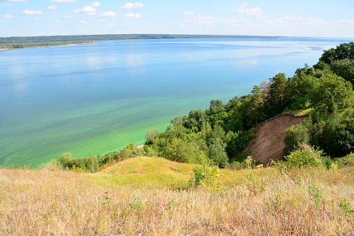 a green hill with Volga river in the background copy space