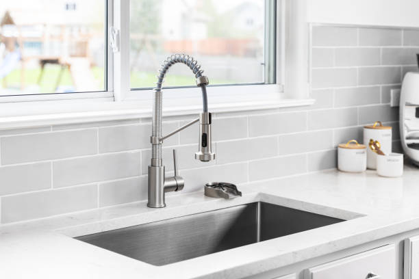 istock A kitchen faucet detail with a marble countertop and subway tile backsplash. 2149711640