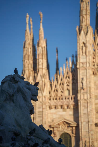 Aerial view of Milan and statue on the roof of Duomo of Milan, Italy