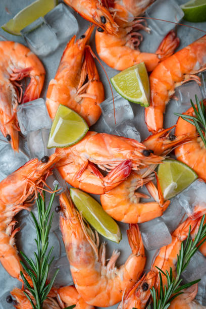 istock Fresh shrimps with ice, lime and rosemary on grey background, top view 2149712755