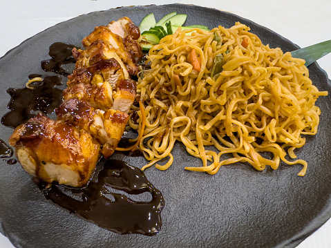A serving of teriyaki pork belly with noodles