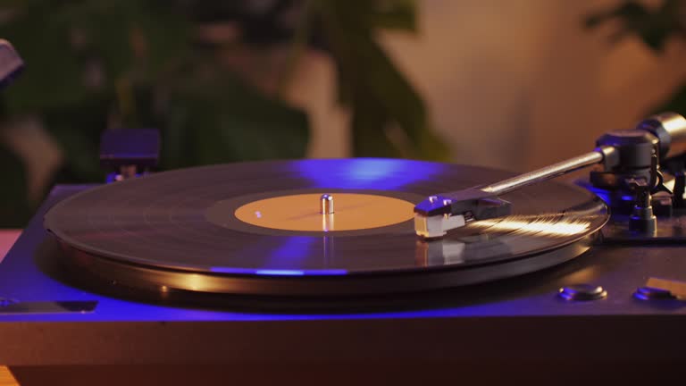 Man Cleaning retro vinyl with special brush - turntable vinyl record player, vintage record player, Sound technologies for DJ to mix and play music.