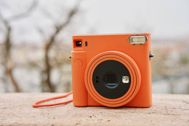 Vintage Orange Instant Camera. Travel shooting equipment