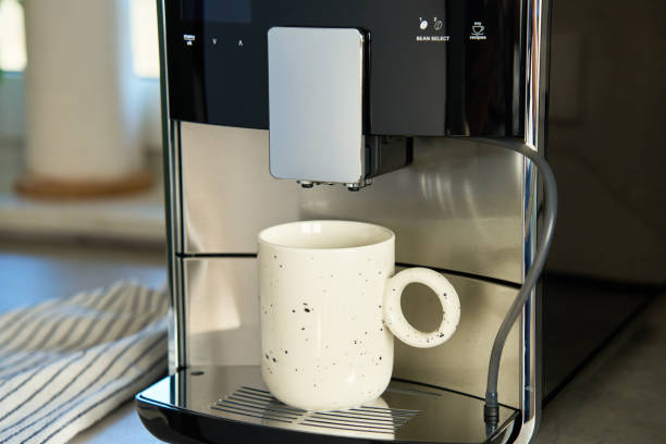 istock Coffee machine with cup of coffee in kitchen 2149720515
