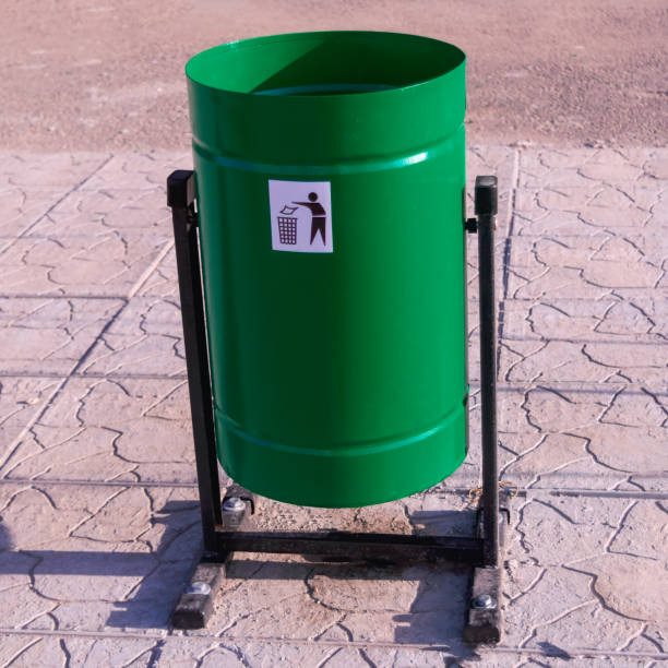 istock Green metal tipping trash can. 2149721082