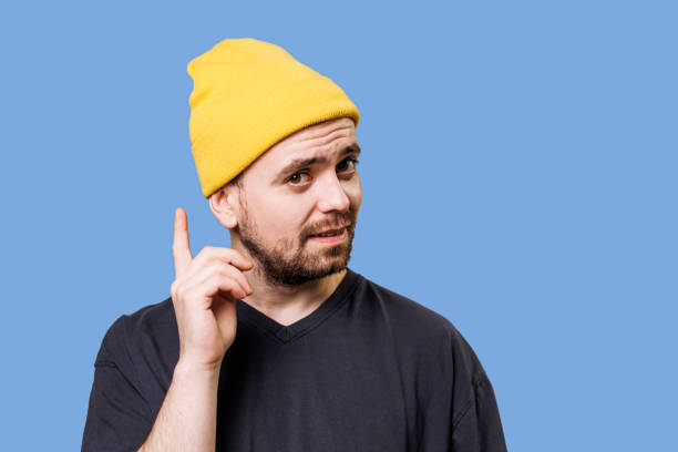 istock Deep in Thought A Male's Contemplative Look, finger warning sign, looking at camera, studio shot 2149721588