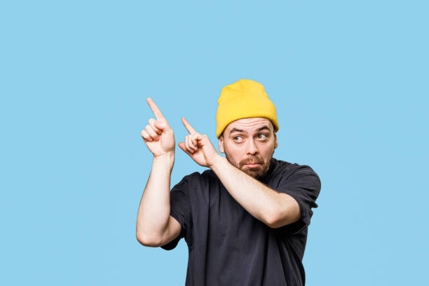 istock Pointing to Free Space, Bizarre Grimace, Studio Portrait with Copy Space 2149721609