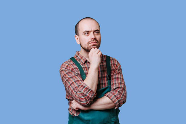 istock a contemplative, serious workman exudes reflection and thoughtfulness in this studio portrait. 2149721643