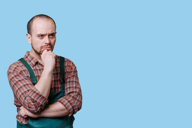 istock Concentrating, pensive workman in studio Serious meditative man in portrait, 2149721665