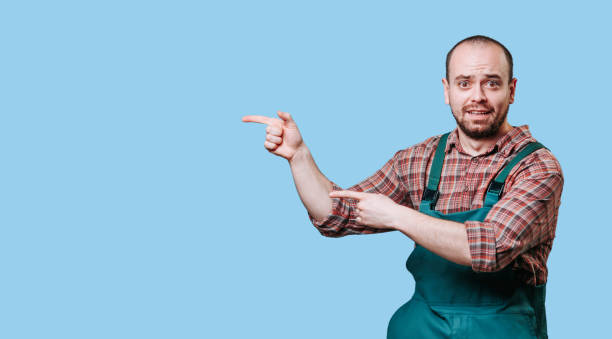 istock man is a staring in amazement and surprise as he points with his hand towards the empty space 2149721680