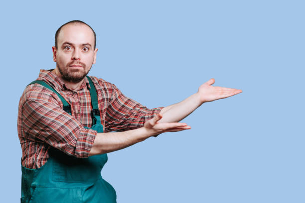 istock The young man, in his coveralls, has a determined expression as he looks at the camera 2149721706