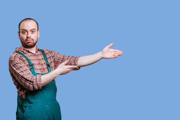istock The guy in coveralls, with a confused look, has his hands outstretched 2149721711