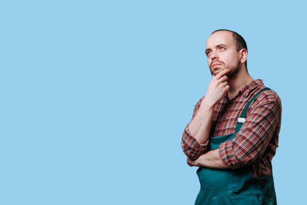 istock Idea filled bearded work man farmer in overalls and a thoughtful pose 2149721721