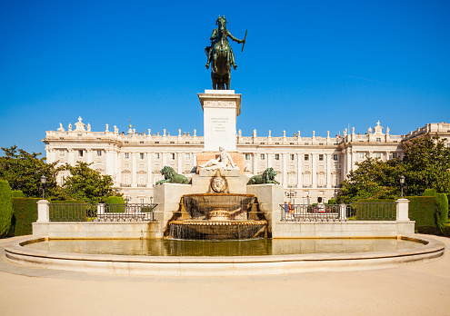 Philip IV of Spain monument and Royal Palace of Madrid, the official residence of the Spanish Royal Family in Madrid, Spain