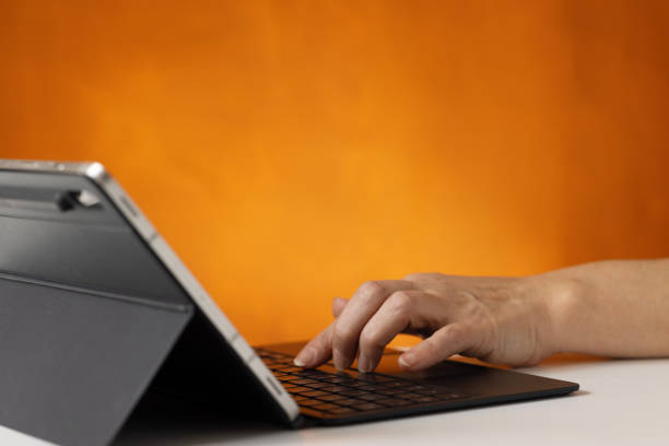 istock Woman's hand checks a bank account on a tablet 2149724292