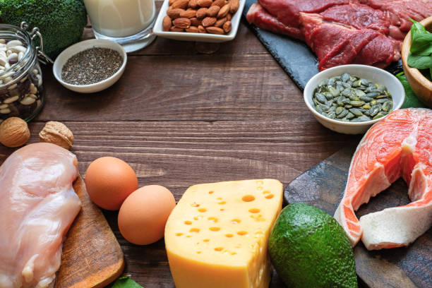 istock Frame made of high protein food sources. Fish, meat, poultry, nuts, cheese, eggs, seeds, vegetables and milk. Healthy eating and balanced food concept. Animal and vegetable sources of protein. 2149725975