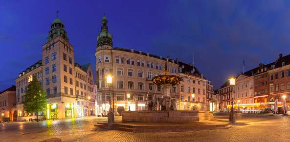 View of a fountain and the central square in the direction of the streets Bahnhofstrasse, Untere Quai and Zentralstrasse in the center of the city's shopping streets. long exposure with light trails of a passing bus. Zentralplatz. 05/13/2021 - 2502 Biel Bienne, canton Bern, Switzerland