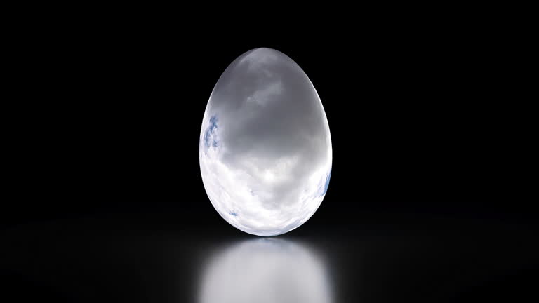 egg on a black background covered with an animated time lapse texture of clouds, concept of the approaching Easter holiday