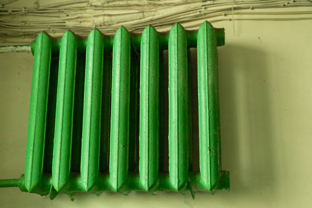 green radiator on the wall, heating the room