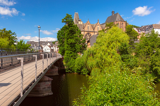 Footbridge over the Lahn river leading to the University Church in Marburg, Germany