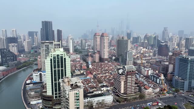 Shanghai city on sunny day, modern buildings in downtown area, high angle view of Suzhou River in Shanghai.