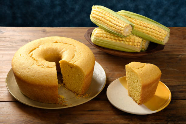 istock Corn cake on a plate on a wooden base, ears of green corn on the table, blue background 2149731662
