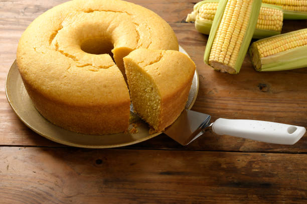istock Corn cake on a plate on a wooden base, ears of green corn on the table, 2149731664