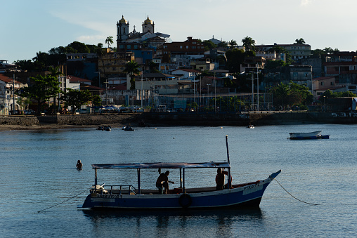 Salvador, Bahia, Brazil - April 13, 2019: View of fishermen on a boat at Ribeira beach in the city of Salvador, Bahia.